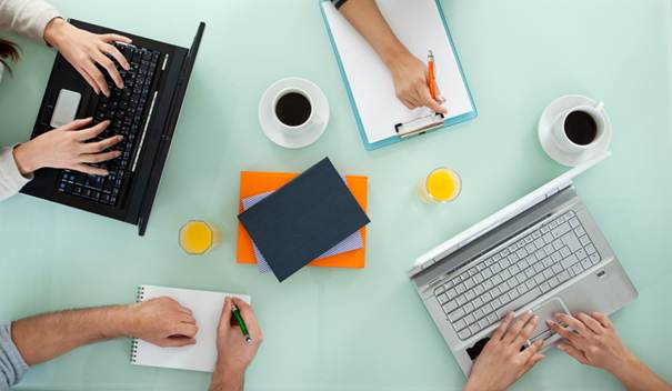 A group of people working on a computer

AI-generated content may be incorrect.